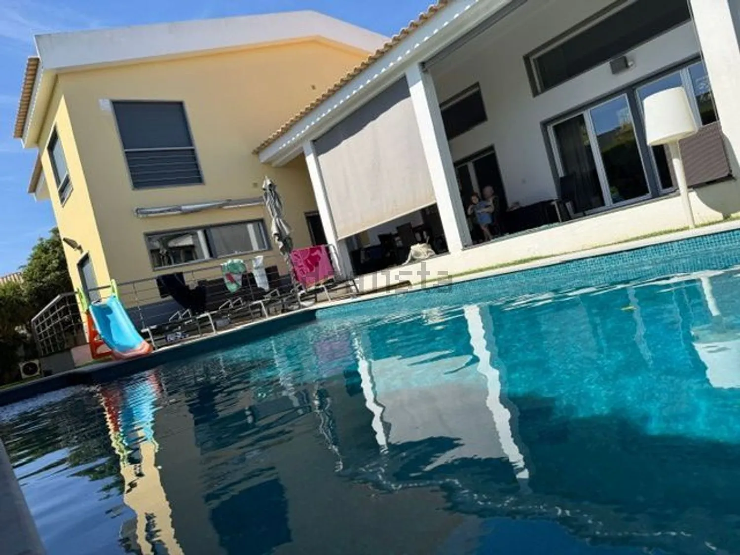The heated pool and the back of the house