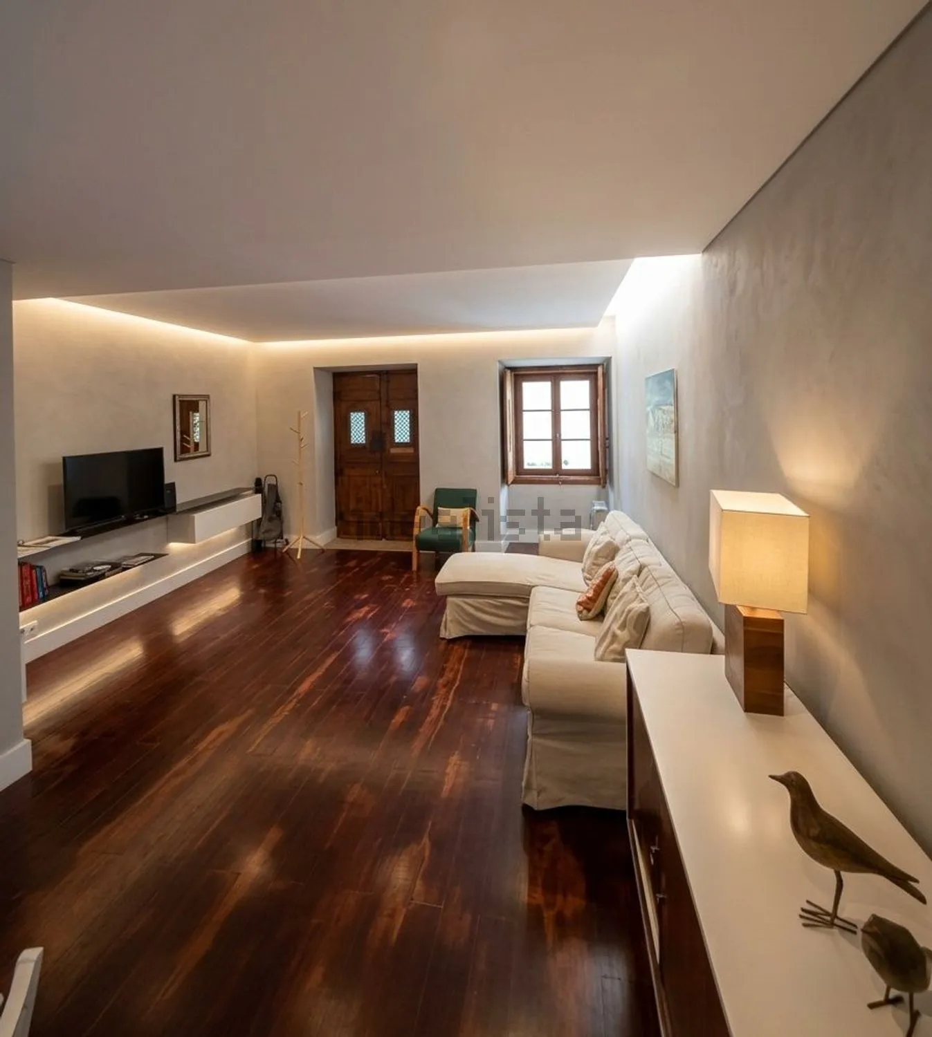 The long living room with wooden floors