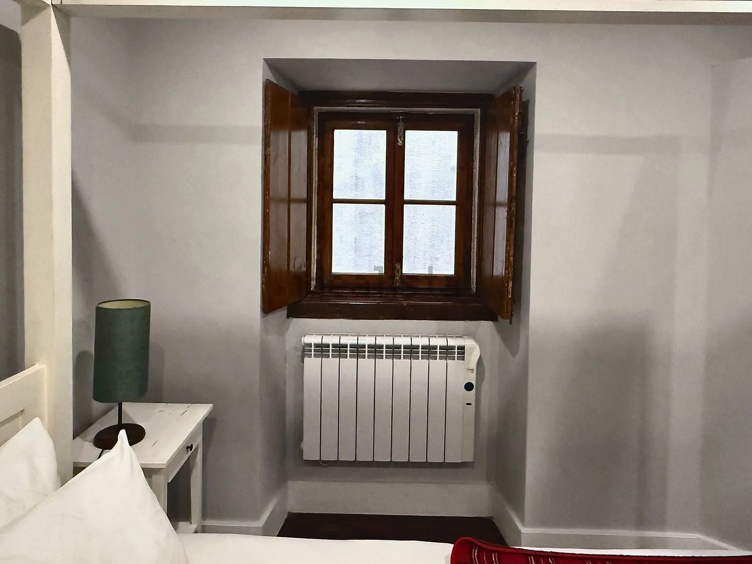 Bedroom window with wooden shutters